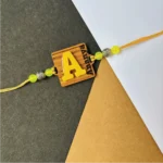 wood initial name rakhi - yellow