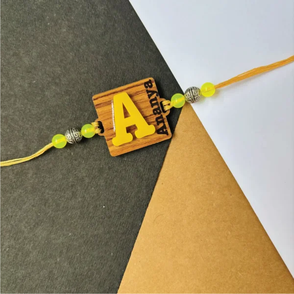 wood initial name rakhi - yellow