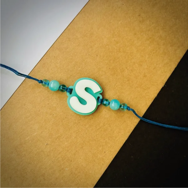 Alphabet rakhi - cyan