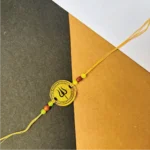 Gold painted trisul rakhi