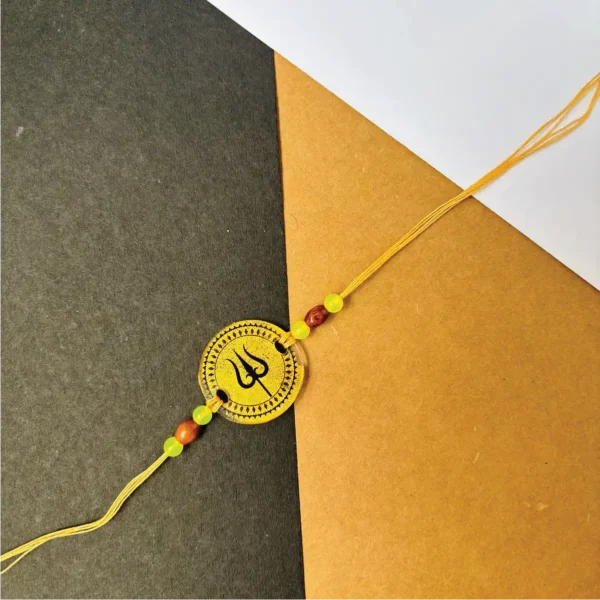 Gold painted trisul rakhi