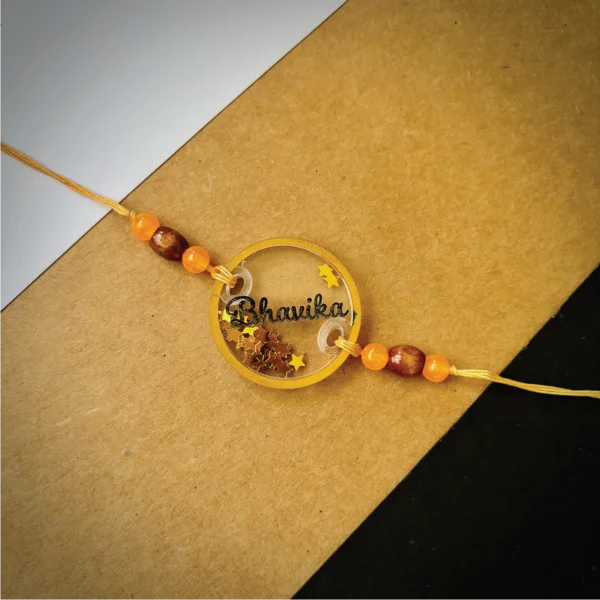 Glitters filled name rakhi - orange