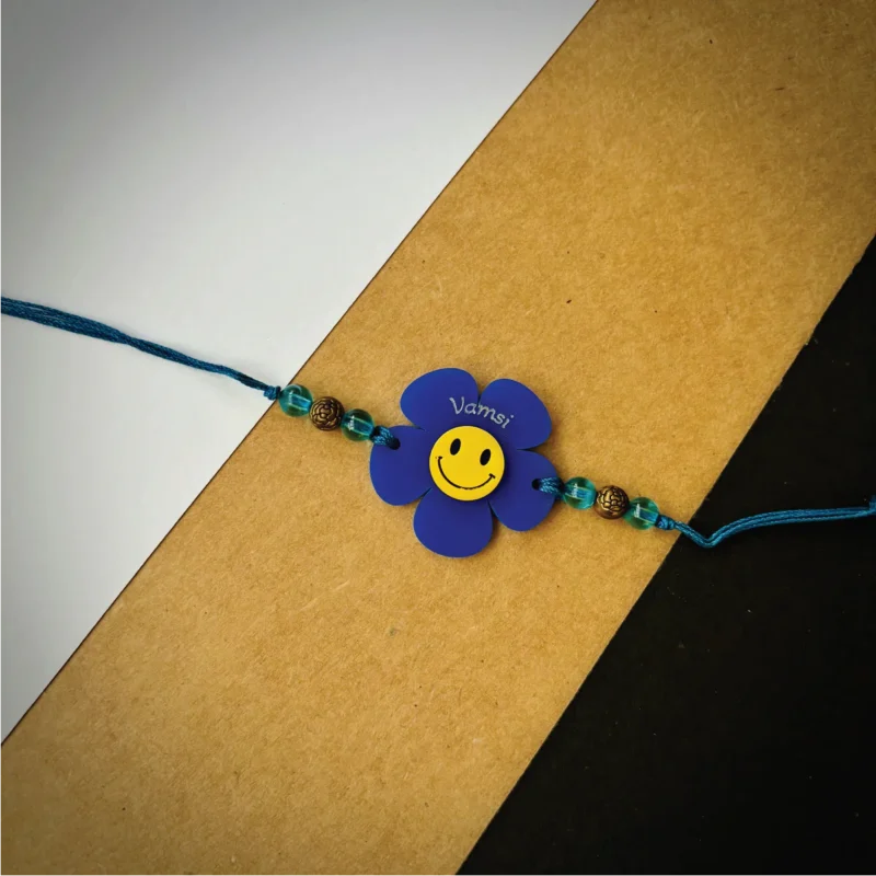 Flower smiley name rakhi - blue