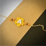 Flower alphabet rakhi - yellow