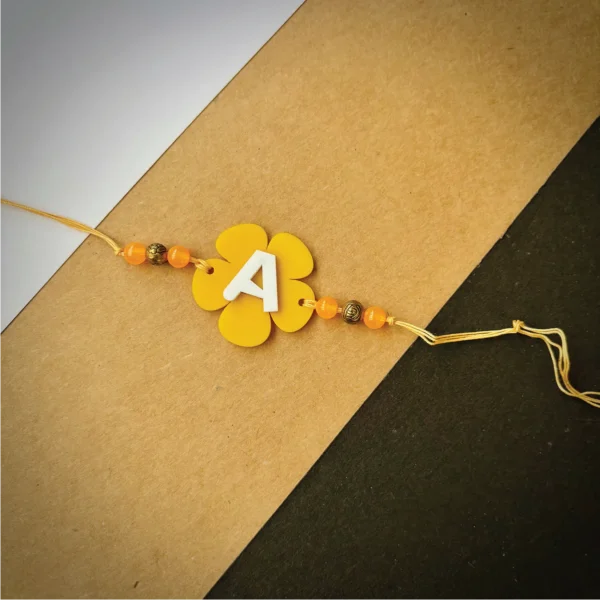 Flower alphabet rakhi - yellow
